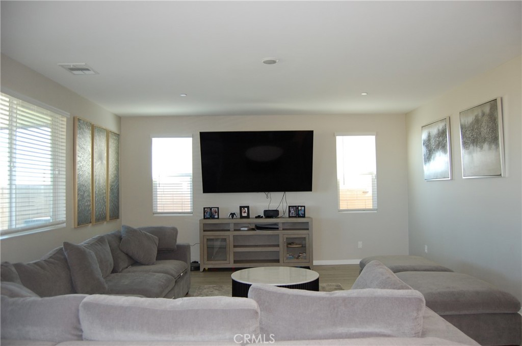 14196 Hercules Street Hesperia, CA 92345 - Photo 10 of 21 a living room with furniture and a flat screen tv
