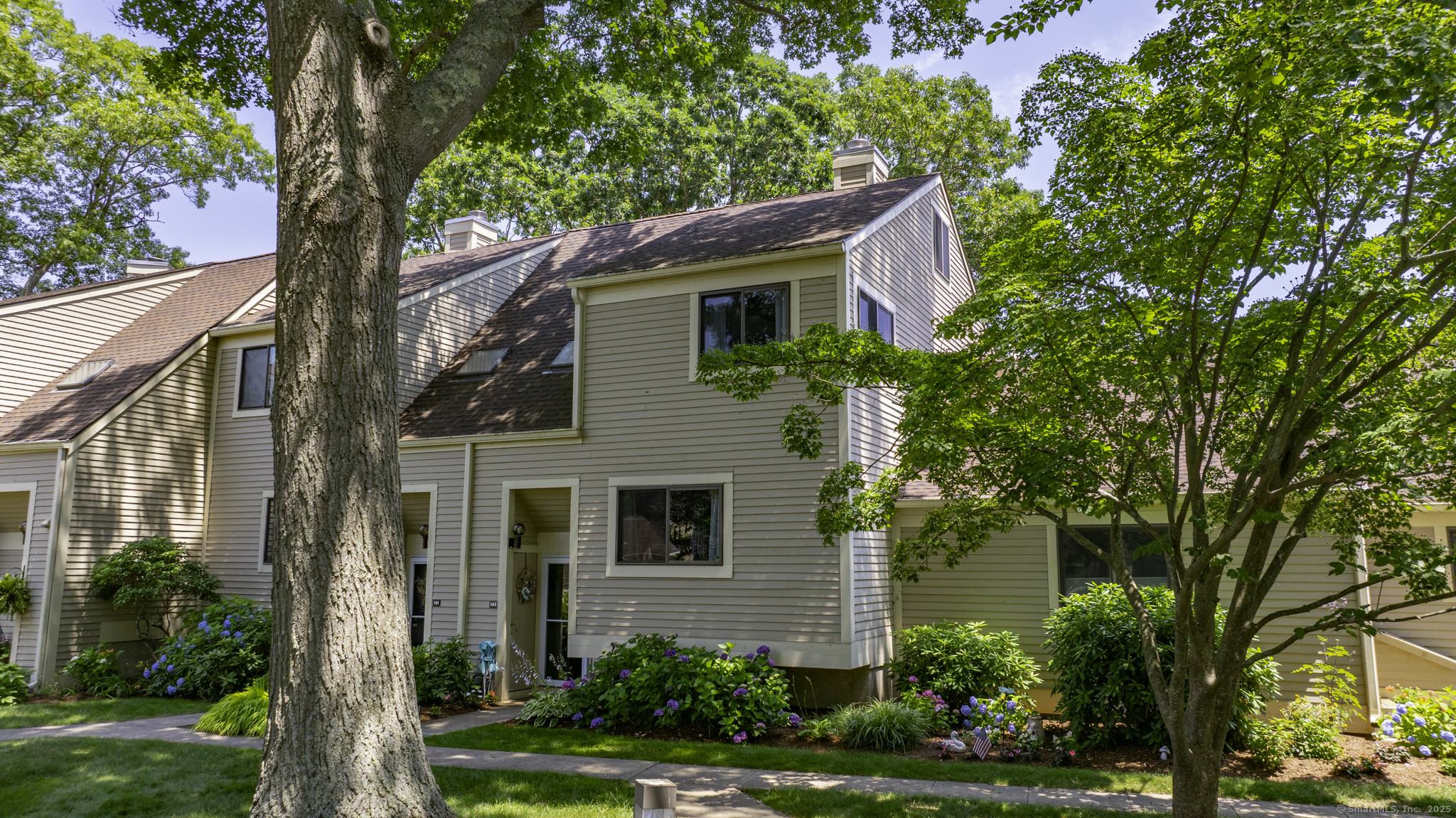 143 Sandy Point Road, Unit 143 Old Saybrook, CT 06475 - Photo 1 of 1 a front view of a house with garden