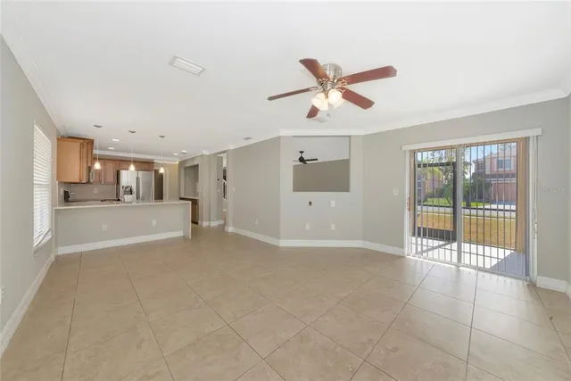 a view of a livingroom with a ceiling fan and window