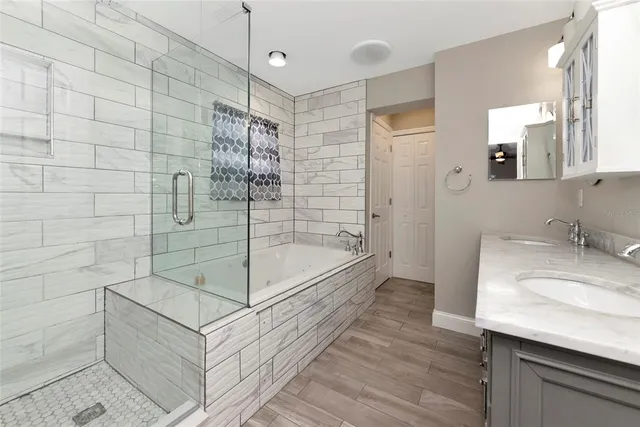 a bathroom with a granite countertop sink a toilet and shower