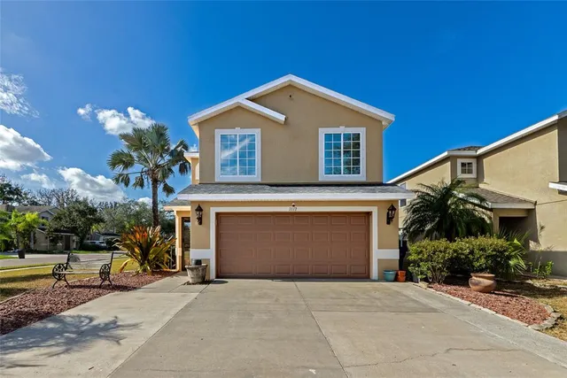a front view of a house with a yard and garage