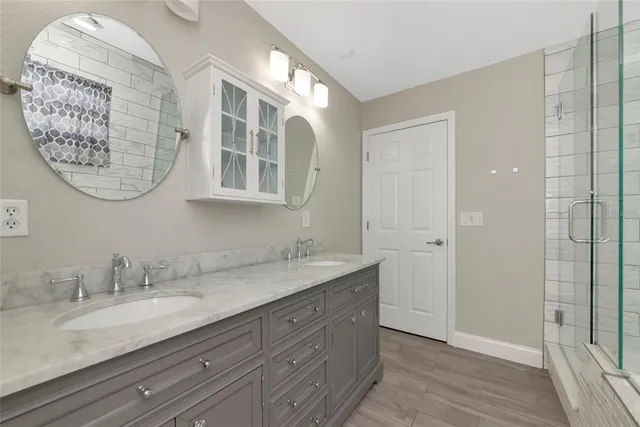 a bathroom with a granite countertop sink mirror and vanity