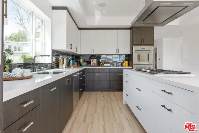a kitchen with stainless steel appliances sink a microwave and cabinets