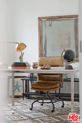 a living room with a table and a potted plant