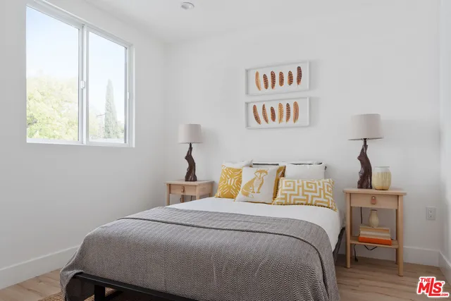 a bedroom with a bed and a night stand