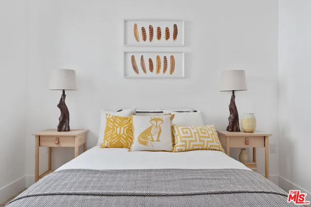 a bedroom with a bed and a night stand