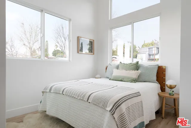 a bedroom with a large bed and a large window