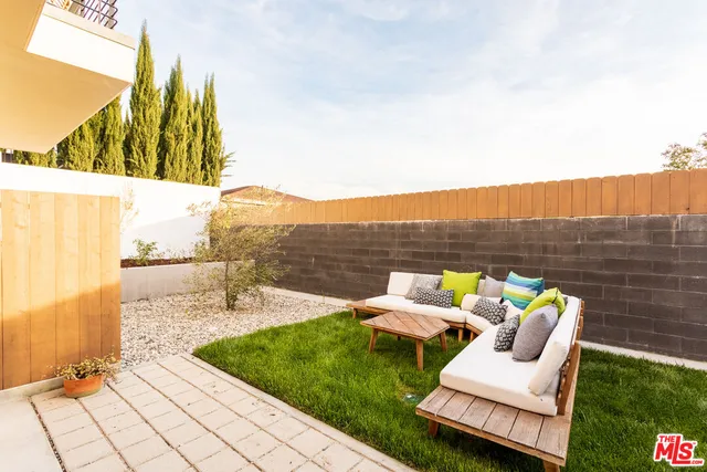 a view of a chairs and table in patio with a yard