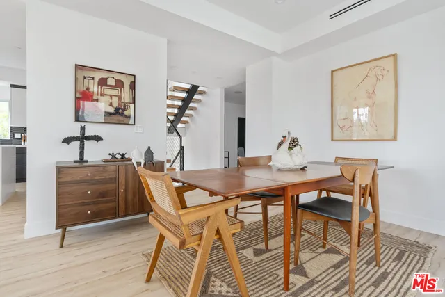 a view of a workspace with furniture and wooden floor
