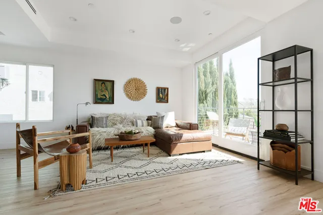 a living room with furniture and a floor to ceiling window
