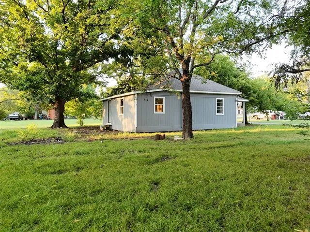 a front view of house with yard and green space