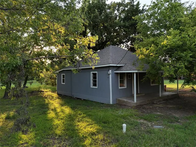 a house with trees in the background