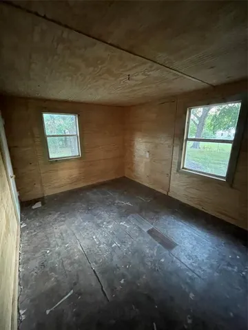 a view of empty room with a fireplace