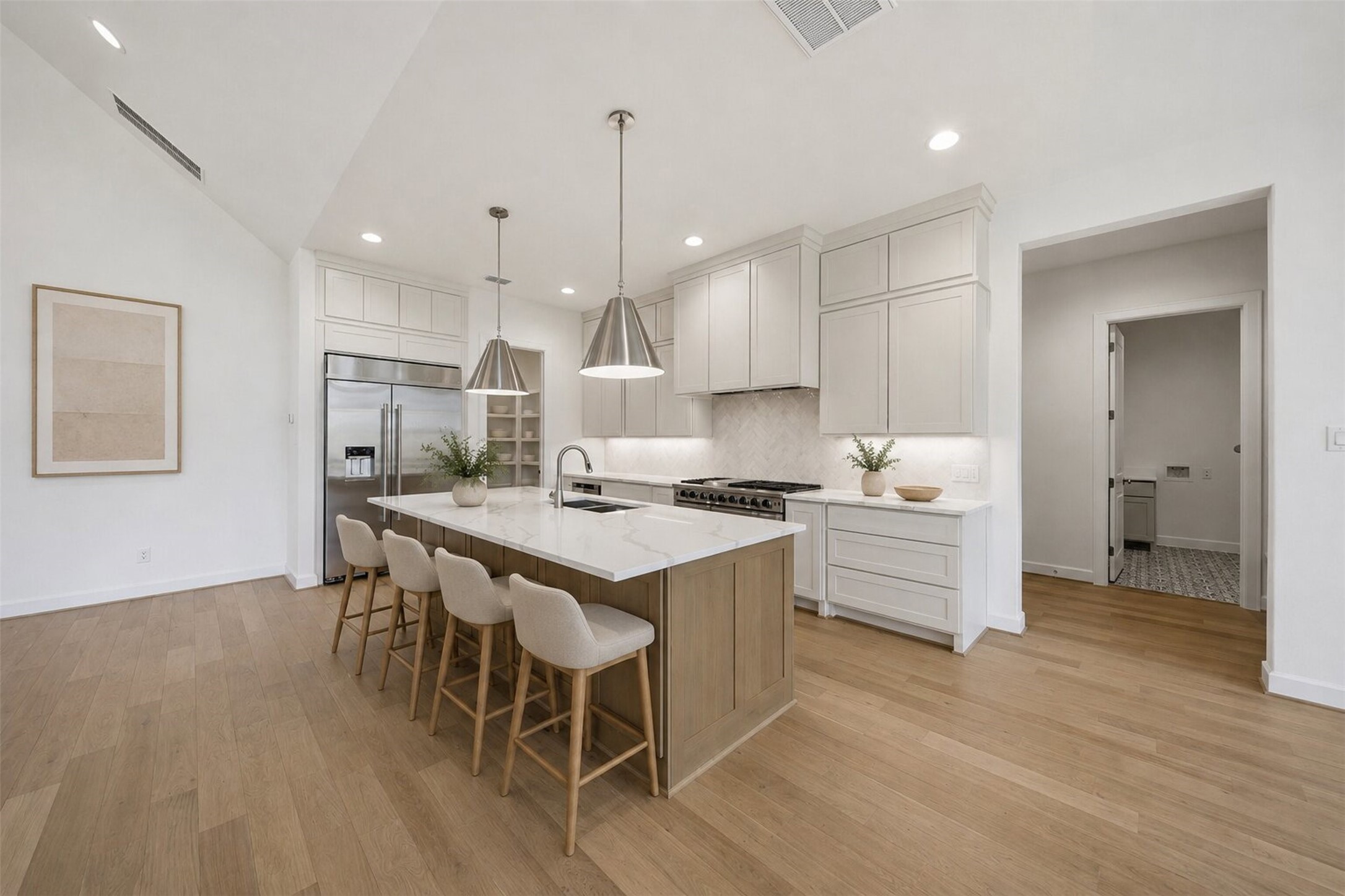 416 Venado View Court Conroe, TX 77304 - Photo 4 of 34 **Virtually Staged** Chef-inspired kitchen showcasing an oversized quartz island, custom cabinetry, premium appliances, and timeless designer finishes.