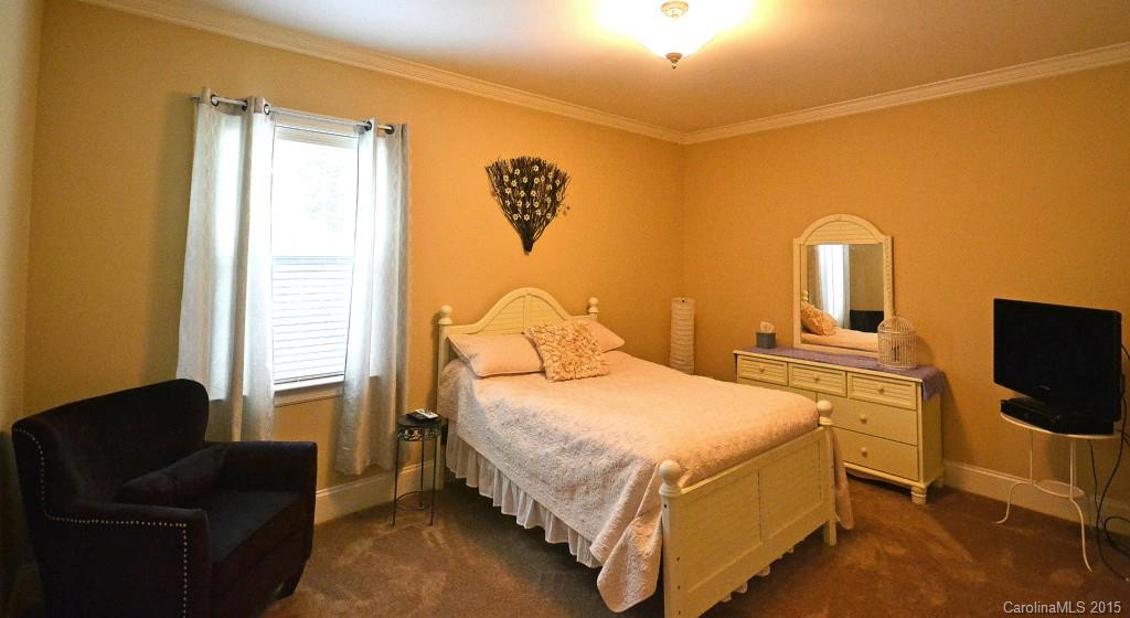 943 Ashford Way Fort Mill, SC 29708 - Photo 14 of 22 a bedroom with a bed and a couch