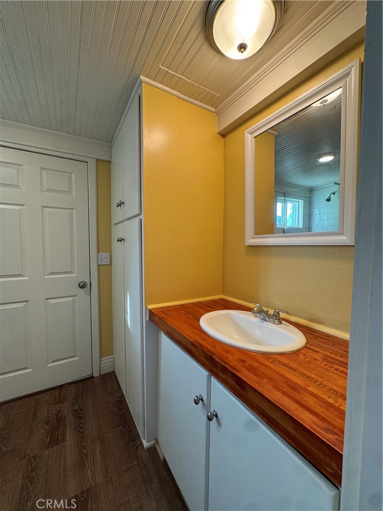 3857 Pine Street Riverside, CA 92501 - Photo 14 of 28 a bathroom with a granite countertop sink and a mirror