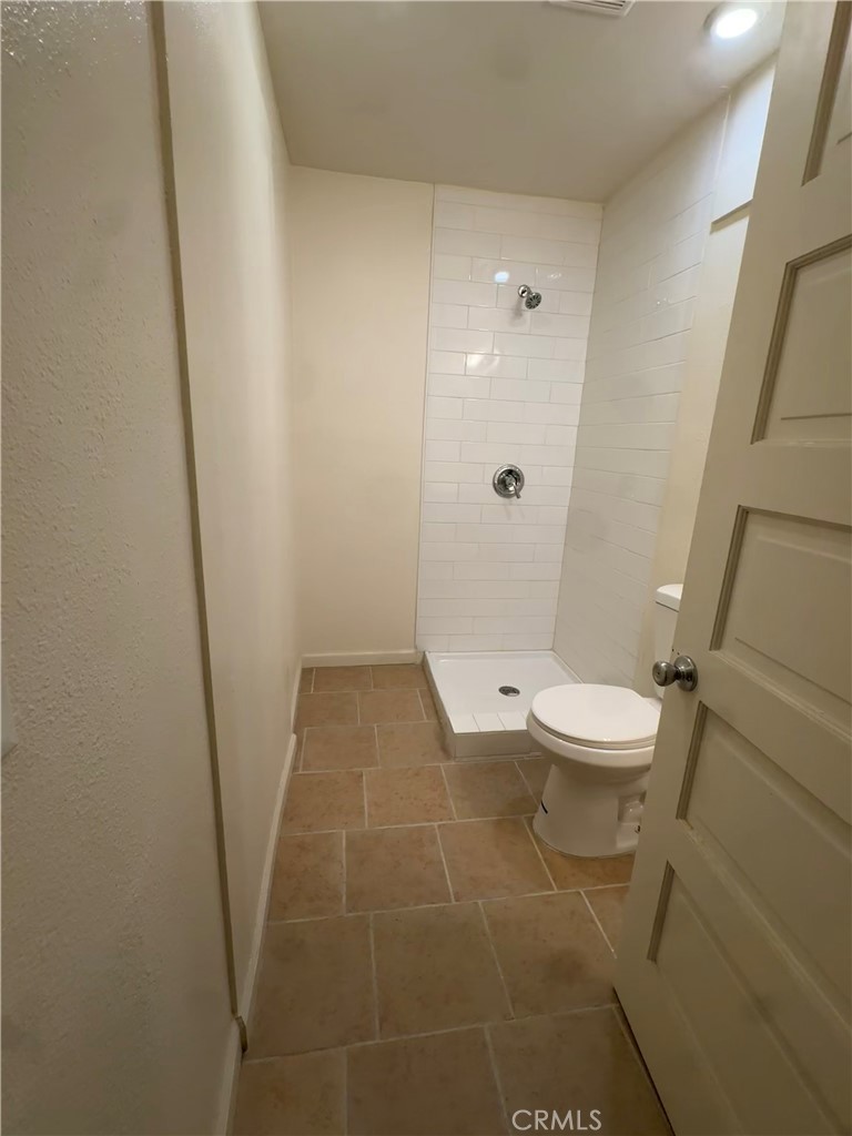 3857 Pine Street Riverside, CA 92501 - Photo 20 of 28 a bathroom with a toilet and a shower