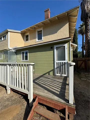 a view of a backyard with wooden fence