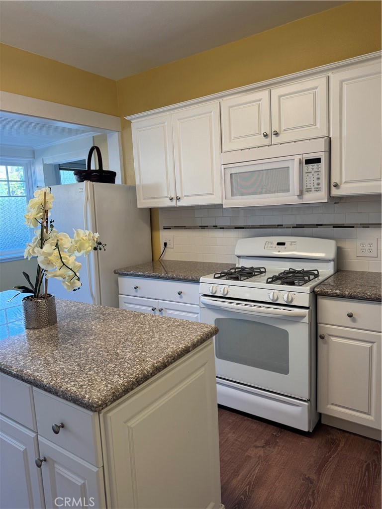 3857 Pine Street Riverside, CA 92501 - Photo 7 of 28 a kitchen with granite countertop a sink cabinets and stainless steel appliances