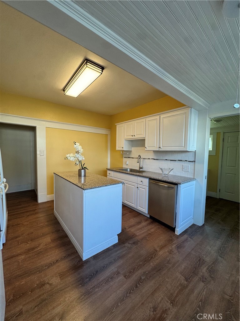 3857 Pine Street Riverside, CA 92501 - Photo 8 of 28 a large kitchen with stainless steel appliances kitchen island a large counter top and a wooden floors