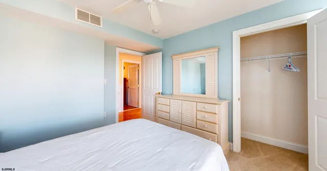 an empty room with a ceiling fan and a window