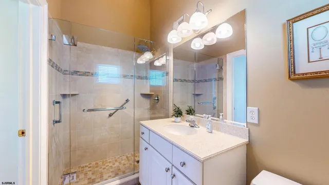 a bathroom with a sink vanity mirror and toilet