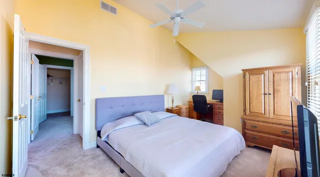 a view of a patio with table and chairs and floor to ceiling window