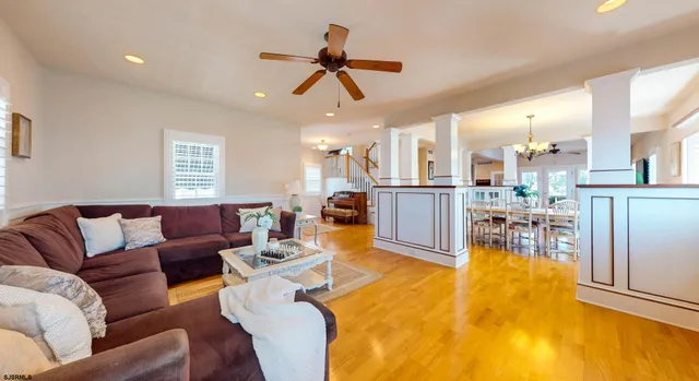 a living room with furniture and kitchen view