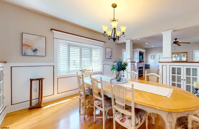 a view of a dining room with furniture and a chandelier