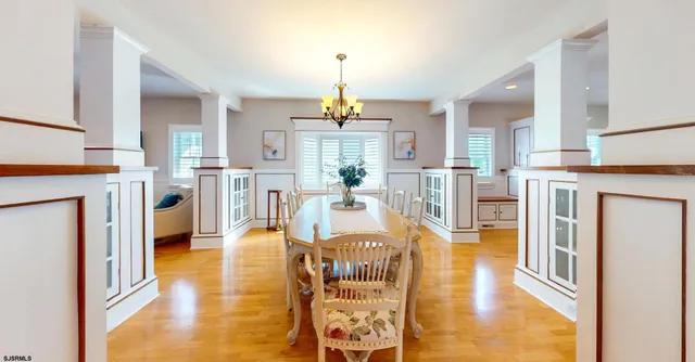 a living room with fireplace furniture and a chandelier
