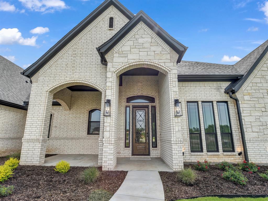 143 Desperado Way Weatherford, TX 76088 - Photo 2 of 36 Entrance to property with brick siding and roof with shingles
