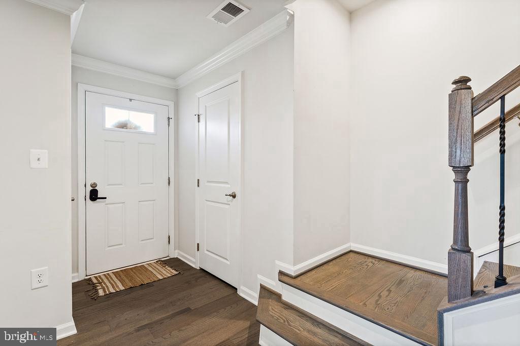 Welcoming entryway with elegant stairs.