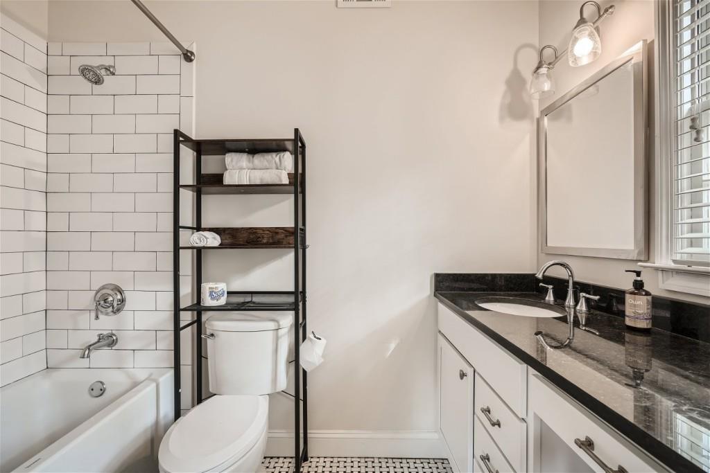 3685 Cantrell Road Northeast Atlanta, GA 30319 - Photo 14 of 25 a bathroom with a granite countertop sink toilet and shower