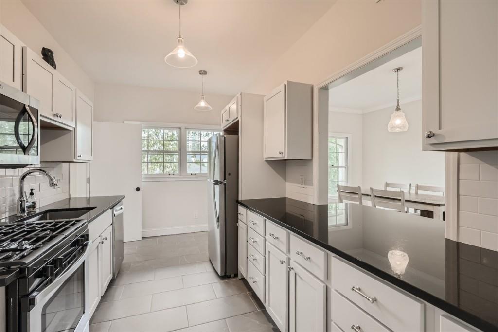 3685 Cantrell Road Northeast Atlanta, GA 30319 - Photo 21 of 25 a kitchen with granite countertop a sink stove and cabinets
