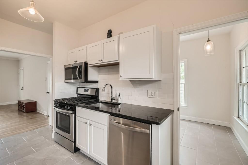 3685 Cantrell Road Northeast Atlanta, GA 30319 - Photo 22 of 25 a kitchen with stainless steel appliances granite countertop a sink and a stove