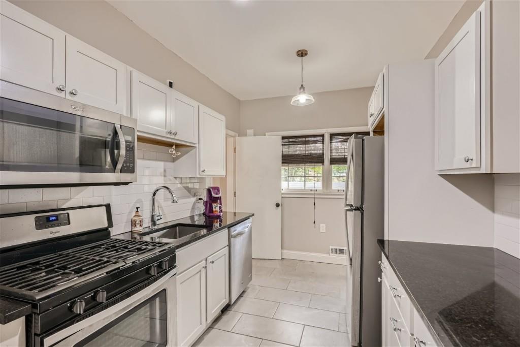 3685 Cantrell Road Northeast Atlanta, GA 30319 - Photo 7 of 25 a kitchen with stainless steel appliances granite countertop a stove and a microwave
