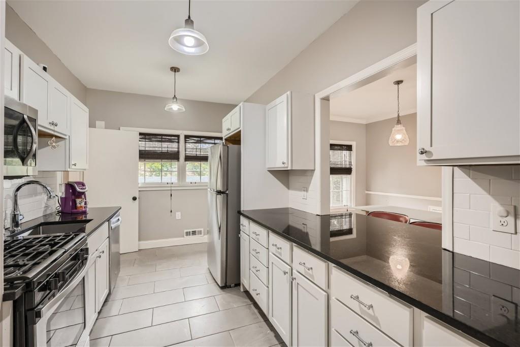 3685 Cantrell Road Northeast Atlanta, GA 30319 - Photo 8 of 25 a kitchen with stainless steel appliances granite countertop a sink counter space cabinets and a stove