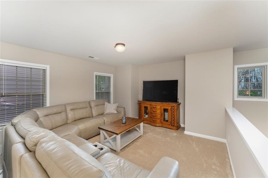 113 Tyson Woods Road Acworth, GA 30102 - Photo 27 of 37 a living room with furniture and a flat screen tv