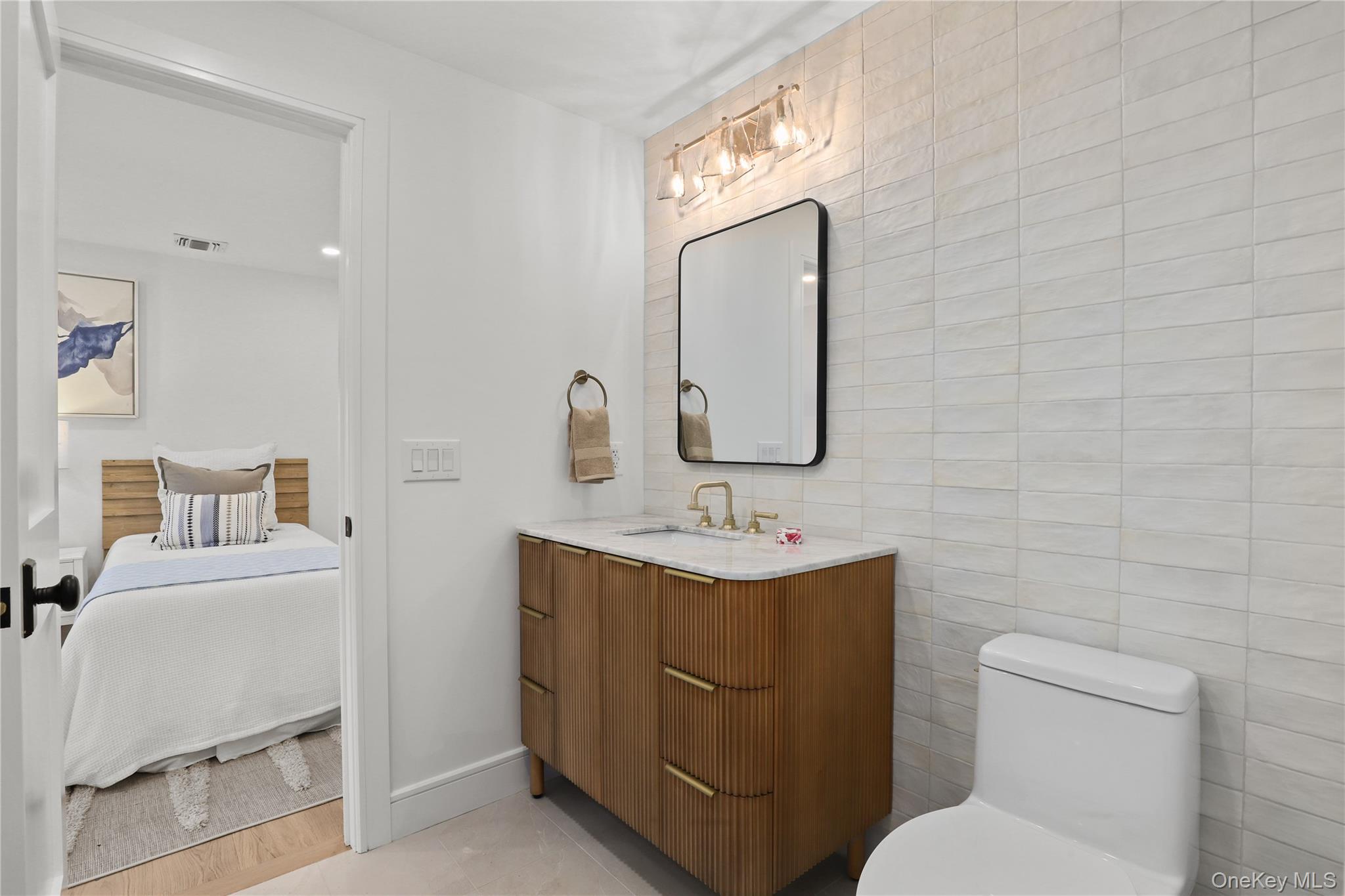 39 Old Snake Hill Road Pound Ridge, NY 10576 - Photo 19 of 37 a bathroom with a toilet a sink and mirror