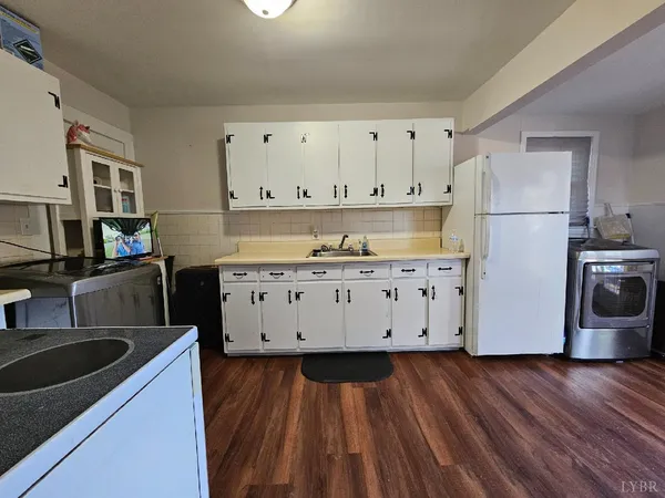 a kitchen with granite countertop white cabinets and stainless steel appliances