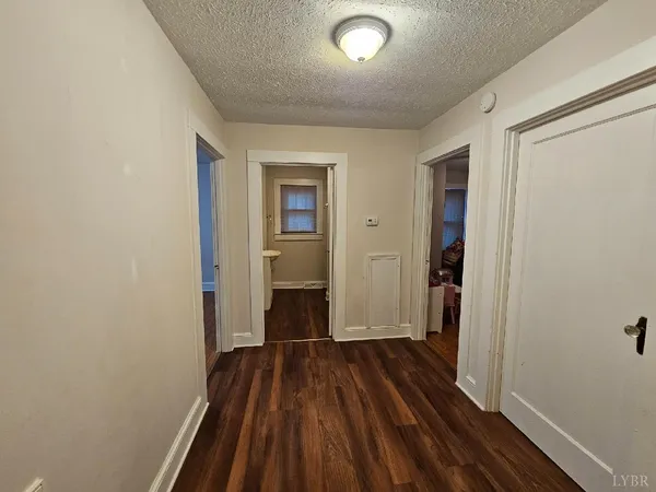 a view of a room with wooden floor a ceiling fan
