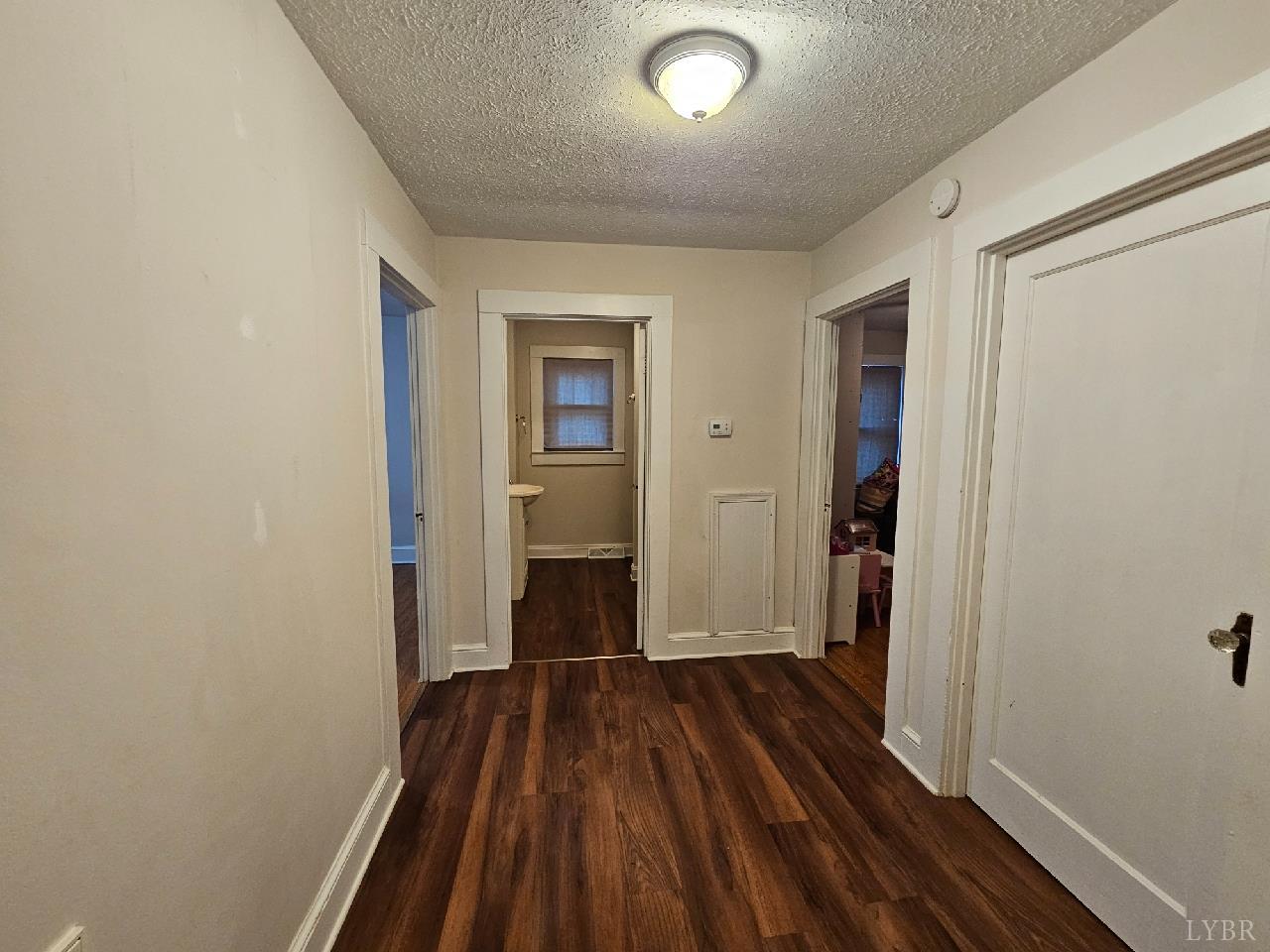 114 Riverview Road Hurt, VA 24563 - Photo 7 of 19 a view of a room with wooden floor a ceiling fan