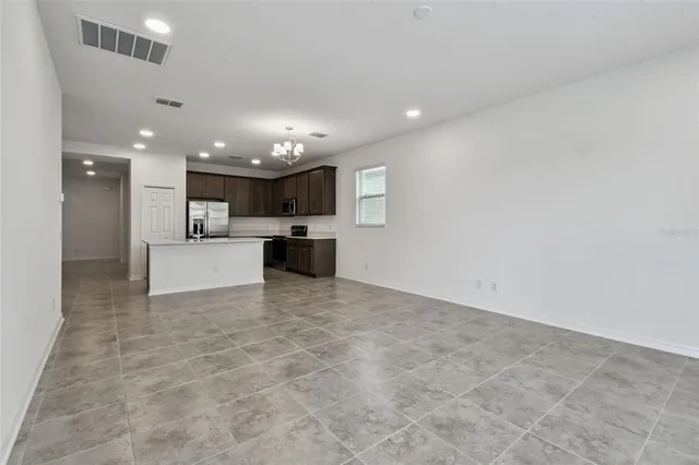 a view of a kitchen with a sink and a refrigerator