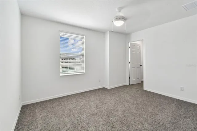 an empty room with a empty space and windows