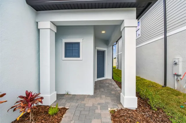 a view of a hallway to a livingroom with furniture