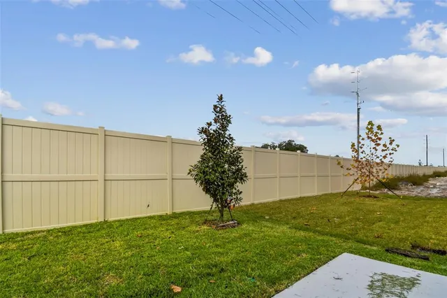 a view of house with backyard