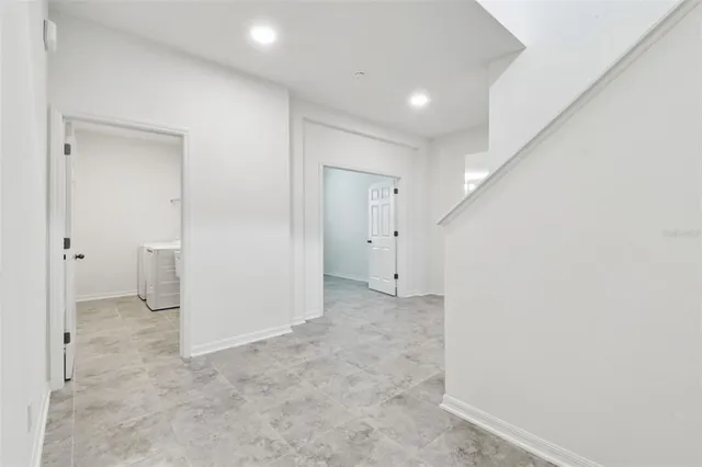 a view of a big room with closet and wooden door