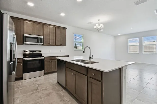 a kitchen with a sink stainless steel appliances and cabinets