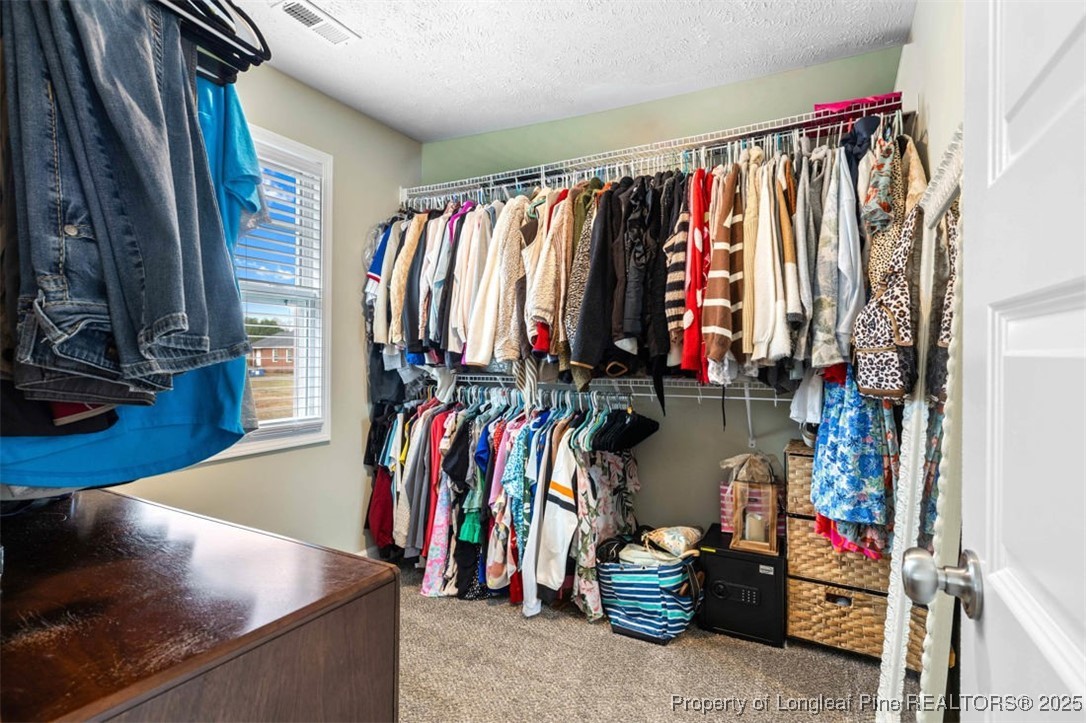 5512 Tolarsville Road St. Pauls, NC 28384 - Photo 23 of 30 a view of walk in closet with clothes