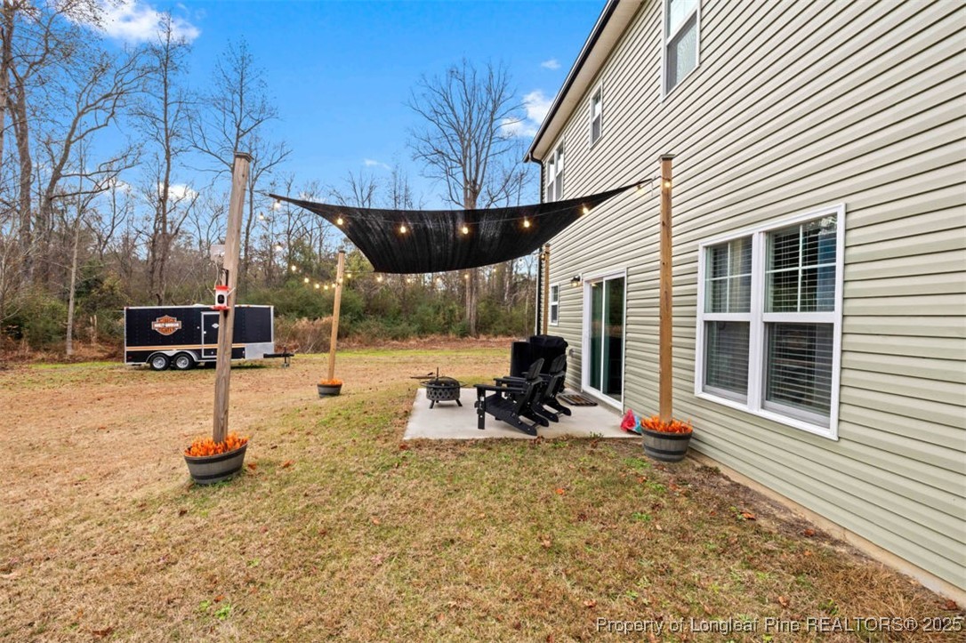 5512 Tolarsville Road St. Pauls, NC 28384 - Photo 27 of 30 a view of a backyard with table and chairs